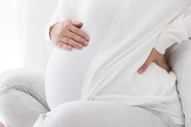 pregnant woman resting due to a backache